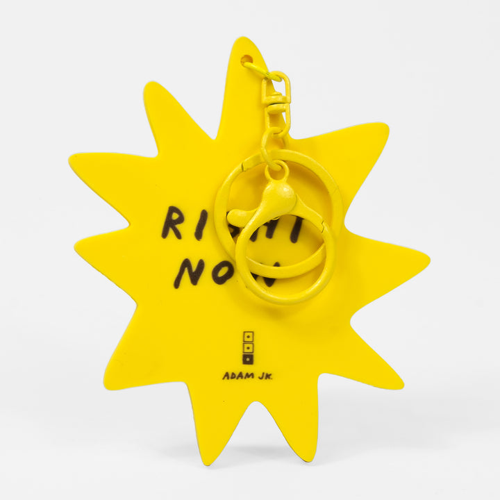 Yellow star-shaped keychain with text on a white background