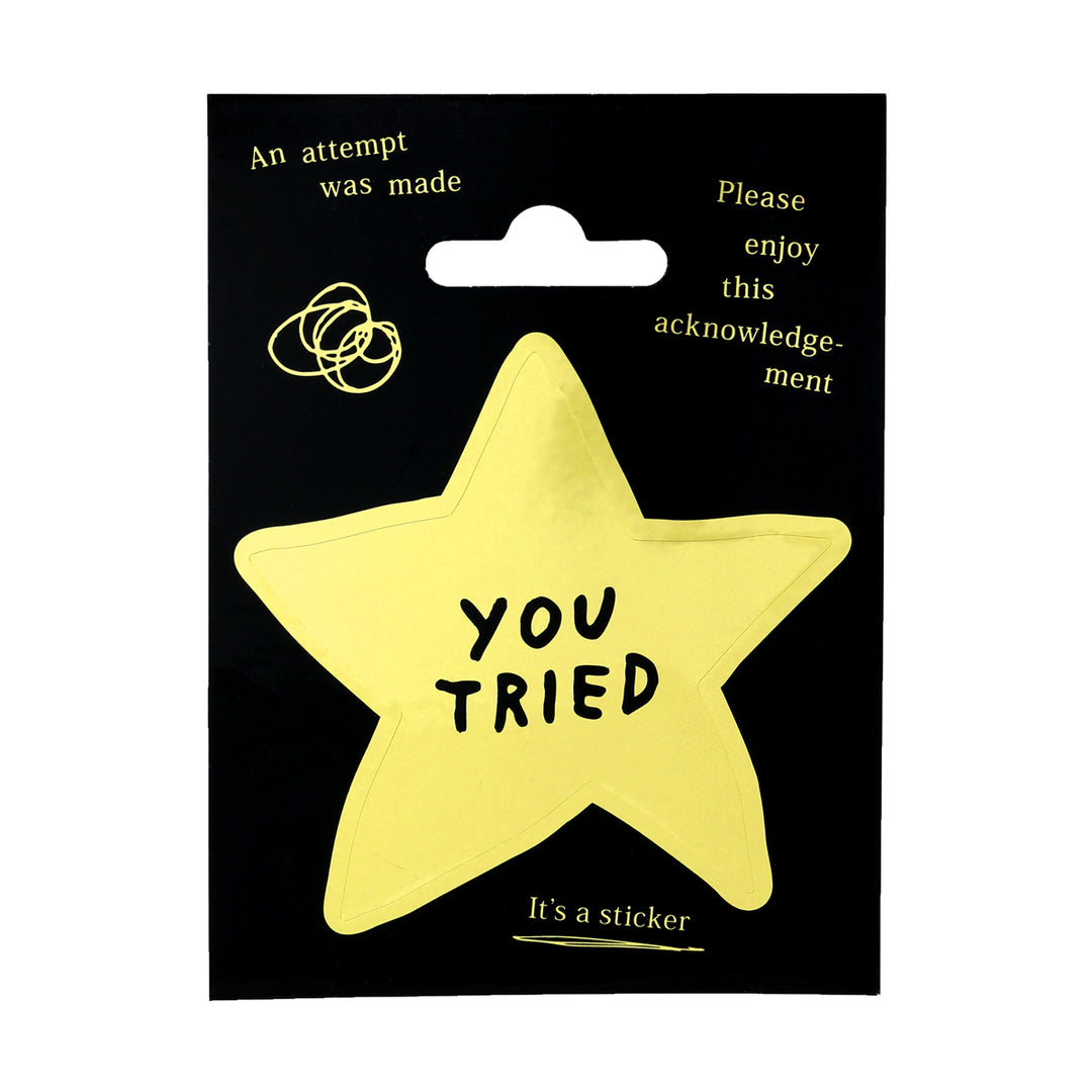 Yellow star-shaped sticker with 'YOU TRIED' text on a black backing card.