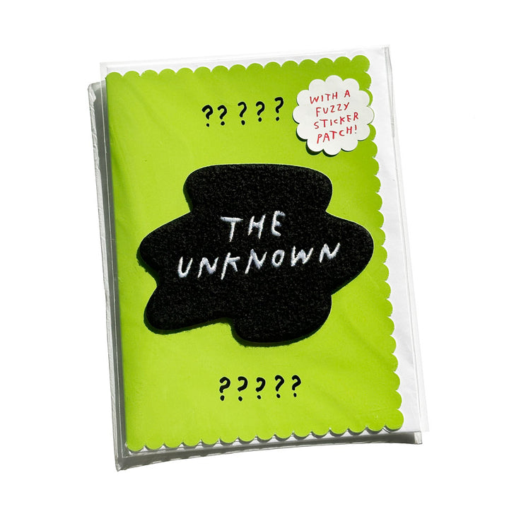 Green greeting card with embroidery patch. Patch reads "THE UNKNOWN" in blob shape.