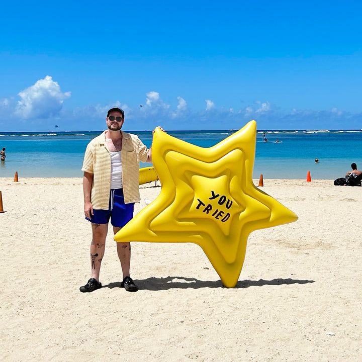 Star shaped pool float says YOU TRIED in Adam's handwriting