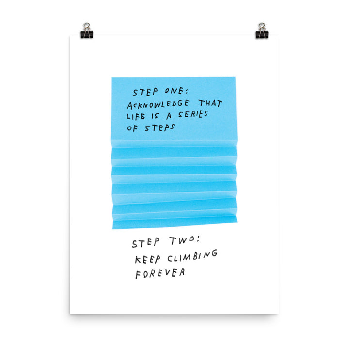 Photo of art print. Blue paper is folded to create steps. Handwritten text reads "Step one: Acknowledge that life is a series of steps. Step Two: Keep climbing forever."